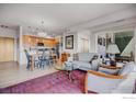 Open-concept living space featuring hardwood floors, modern decor, and natural light at 1585 Hecla Way # 304, Louisville, CO 80027