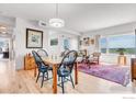 Open-concept living and dining area with hardwood floors and ample natural light at 1585 Hecla Way # 304, Louisville, CO 80027