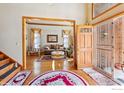 Inviting home foyer showcasing hardwood floors, an open floor plan, and warm, natural light at 16261 W Ellsworth Ave, Golden, CO 80401