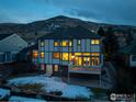 Back of home featuring large windows, a deck and views of the mountain in the background at 16261 W Ellsworth Ave, Golden, CO 80401