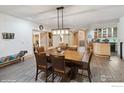 Well-lit dining area features a rustic wooden table and chairs, with stylish decor and bar area at 1682 Montane E Dr, Golden, CO 80401