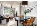 Open living and dining area, boasting modern design with concrete ceilings and bright natural light at 1700 Bassett St # 409, Denver, CO 80202
