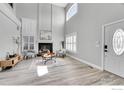 Bright living room with vaulted ceilings, fireplace, and lots of light from windows with white shutters at 19731 E 40Th Ave, Denver, CO 80249
