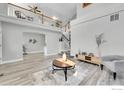 Spacious living area with vaulted ceilings, fireplace, and a gray accent chair create a cozy atmosphere at 19731 E 40Th Ave, Denver, CO 80249