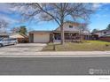 Charming two-story home featuring a front porch and a well-manicured lawn at 2226 Judson St, Longmont, CO 80501