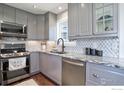 Well-lit kitchen with granite counters, stainless steel appliances, and tiled backsplash at 24057 Matterhorn Dr, Indian Hills, CO 80454