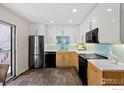 Modern kitchen with sleek white cabinets, stainless steel appliances, and a stylish backsplash at 2420 9Th St # 4, Boulder, CO 80304