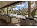 Inviting porch view, showing the street and surrounding neighborhood with mature trees at 2420 9Th St # 4, Boulder, CO 80304