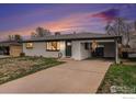 Charming ranch-style home featuring a freshly painted exterior and an attached carport at 2566 S Stuart St, Denver, CO 80219