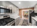 Modern kitchen boasts stainless steel appliances, grey cabinets and light countertops at 2566 S Stuart St, Denver, CO 80219