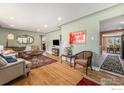 Spacious living room features hardwood floors, stylish furnishings, and great natural light at 2566 S Stuart St, Denver, CO 80219