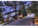Charming home exterior features a well-maintained driveway, mature trees, and lovely landscaping at 36 High View Dr, Boulder, CO 80304