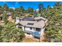 Stunning home with solar panels, balcony, and lush trees offering privacy and charm at 36 High View Dr, Boulder, CO 80304
