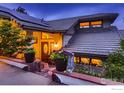 Charming home with stone-lined garden beds, a custom front door, and tasteful landscaping in front at 36 High View Dr, Boulder, CO 80304
