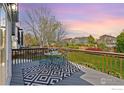 Cozy back deck with outdoor seating, a patterned rug, and scenic views of the backyard and neighborhood at 407 Simmons St, Erie, CO 80516