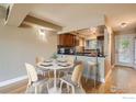 Cozy kitchen and dining area with wood cabinets, granite countertops, and stainless steel appliances at 4800 Osage Dr # 4A, Boulder, CO 80303
