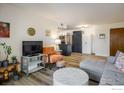Cozy living room with modern decor, hardwood floors, and an open view to the kitchen at 5120 Williams Fork Trl # 214, Boulder, CO 80301