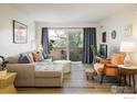 Bright living room features a comfortable sofa, balcony access, and stylish decor at 5120 Williams Fork Trl # 214, Boulder, CO 80301
