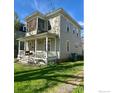 Two-story home boasting a cozy front porch, perfect for relaxing outdoors at 525 Gay St, Longmont, CO 80501