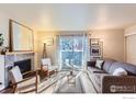 Living room with a cozy fireplace, access to the outside through sliding glass doors, and neutral walls for versatile decorating at 695 Manhattan Dr # 22, Boulder, CO 80303
