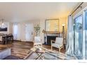 Open-concept layout features a fireplace, dining area, and access to outdoor through glass doors for seamless indoor/outdoor living at 695 Manhattan Dr # 22, Boulder, CO 80303