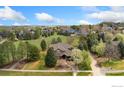 Expansive aerial view of a home nestled among lush trees and green spaces, showcasing the generous lot size at 7220 Spring Creek Cir, Niwot, CO 80503
