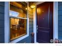 Inviting entryway with a view of the modern kitchen featuring an island and stainless steel appliances at 8482 Parkland St, Broomfield, CO 80021