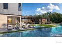 Stunning modern home with a backyard pool, multiple lounge areas, and an open patio at 855 Kalmia Ave, Boulder, CO 80304