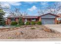 Charming brick home with a well-maintained front yard and an attached two-car garage at 10249 W Grand Ave, Littleton, CO 80127