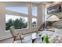 Bright living room boasting large windows with scenic views, a modern staircase, and stylish decor at 1048 Westview Dr, Boulder, CO 80303