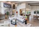 Spacious living room featuring an open floor plan, modern staircase, and seamless flow into the dining and kitchen areas at 1048 Westview Dr, Boulder, CO 80303