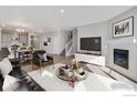 Bright living room featuring contemporary furnishings, a cozy fireplace, and an open-concept layout at 1102 Ridgefield Dr, Berthoud, CO 80513