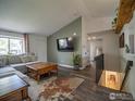 Cozy living room with hardwood floors, a mounted TV, and staircase access at 13146 Raritan Ct, Westminster, CO 80234