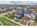 Aerial view showcasing a home with solar panels in a neighborhood near the mountains at 1356 Golden Eagle Way, Louisville, CO 80027