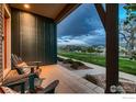 Inviting front porch with seating, offering a view of the lawn and neighborhood at 1356 Golden Eagle Way, Louisville, CO 80027