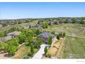 Beautiful home with a large yard, mature trees, and views of the neighborhood at 14958 Wistera Way, Broomfield, CO 80023