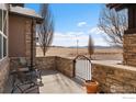 Inviting patio with stone surround perfect for relaxing and enjoying outdoor views at 14958 Wistera Way, Broomfield, CO 80023