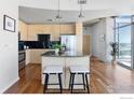Stylish kitchen boasts stainless steel appliances, granite countertops, and a black tile backsplash at 1700 Bassett St # 1303, Denver, CO 80202