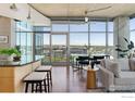Open living space with floor-to-ceiling windows offering beautiful city views from the dining area at 1700 Bassett St # 1303, Denver, CO 80202