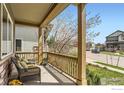 Inviting front porch offering neighborhood views, seating, and charming curb appeal at 1833 Sweet Clover Ln, Louisville, CO 80027