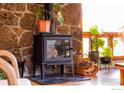 Close-up of wood burning stove and stone fireplace, complemented by natural light at 2015 Kohler Dr, Boulder, CO 80305