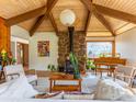 Spacious living room with vaulted ceilings, stone fireplace, piano, and stylish furnishings at 2015 Kohler Dr, Boulder, CO 80305