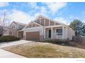 Inviting single-Gathering home featuring a covered front porch and a two-car garage at 20336 Willowbend Ln, Parker, CO 80138