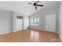 Cozy living room featuring beautiful hardwood floors, a ceiling fan, and a window at 20336 Willowbend Ln, Parker, CO 80138