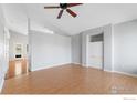 Bright living room with hardwood floors, ceiling fan, and freshly painted walls at 20336 Willowbend Ln, Parker, CO 80138