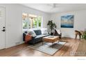Bright living room with hardwood floors, neutral decor, and a large window at 220 28Th St, Boulder, CO 80305