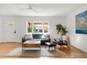 Bright living room with hardwood floors, neutral decor, and a large window at 220 28Th St, Boulder, CO 80305