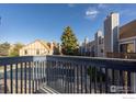 Balcony with a view of the community pool, green spaces and neighboring townhomes at 225 E 8Th Ave # D20, Longmont, CO 80504