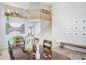 Spacious entryway featuring a staircase, wood floors, and elegant decor at 2279 Apple Tree Pl, Erie, CO 80516