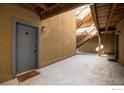Condo exterior features unit entry, stairway, and overhead beams for a rustic and functional architectural touch at 2711 Mapleton Ave # 1, Boulder, CO 80304